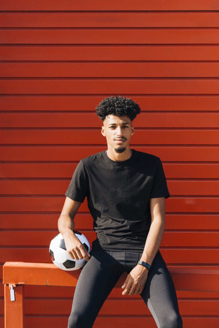 young-ethnic-man-sitting-with-soccer-ball (1)